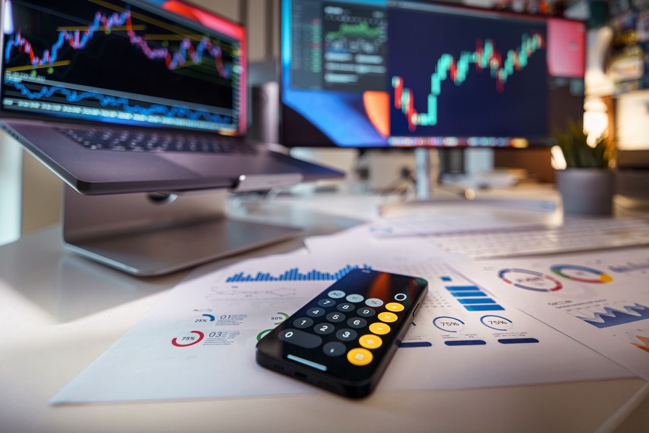 Modern workspace showcasing financial analysis with digital charts and reports.
